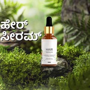 Amber glass bottle of hair serum with a white label, set against a lush green forest background.
