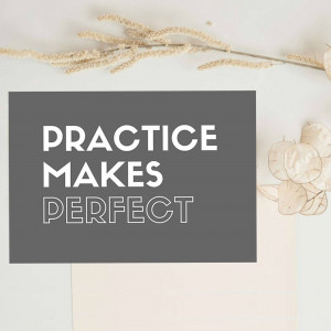 A card with the text 'PRACTICE MAKES PERFECT' surrounded by dried flowers.