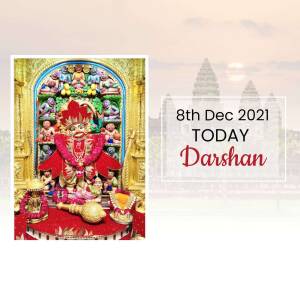 Image of Hanuman idol decorated with flowers and a ceremonial mace, with text indicating a Darshan on December 8th, 2021.