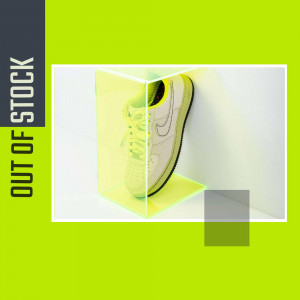 A pair of white sneakers displayed in a transparent acrylic case with a vibrant green background.