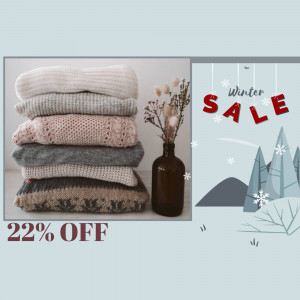 Stack of cozy sweaters with a winter sale promotion