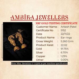 Gold earrings certificate from Ambika Jewellers with details of gold purity and weight.