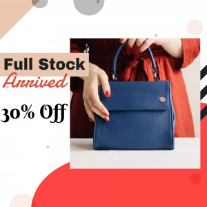 Woman holding a blue leather handbag with a sale announcement.