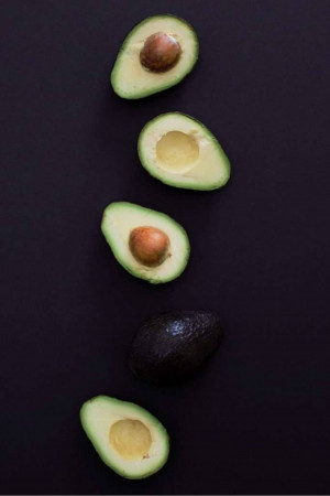 Sliced avocado on a dark background