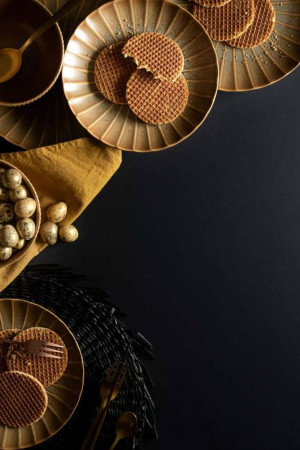 Close-up of stroopwafels, chocolate eggs, and decorative elements on a dark background