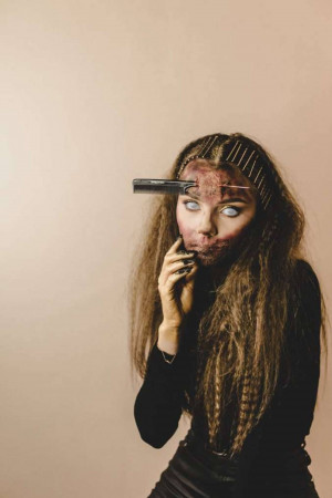 Woman with detailed zombie makeup looking at the camera