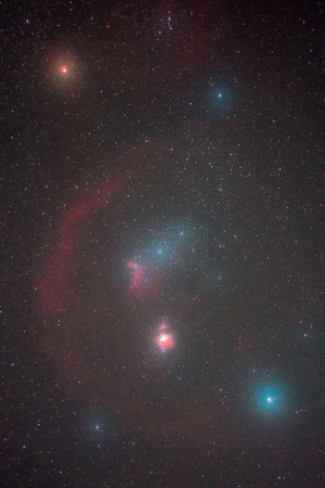 A stunning long-exposure photograph of a colorful nebula in deep space.