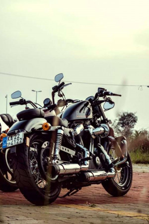 Two black Harley Davidson motorcycles parked side-by-side
