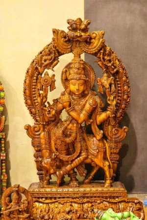 Detailed carving of Lord Krishna with a cow
