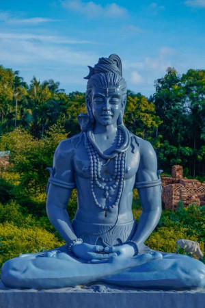 A serene statue of Lord Shiva in a meditative pose.