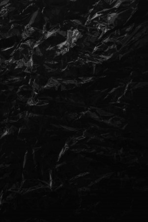 Close-up of crumpled black plastic texture