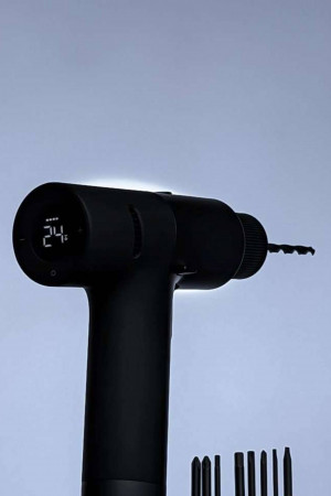 Close-up of a black Xiaomi Mijia electric screwdriver with a digital display and bits.