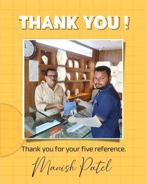 Manish Patel, owner of a jewelry store, handing a customer a reference card.