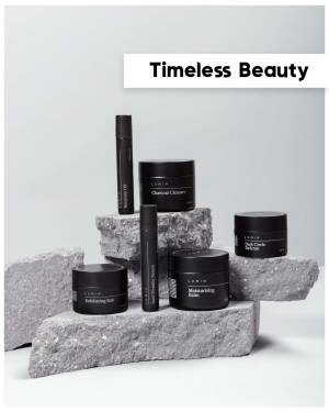 Lumin skincare products arranged on gray rocks