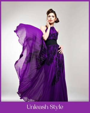 A stunning woman in a flowing purple evening gown