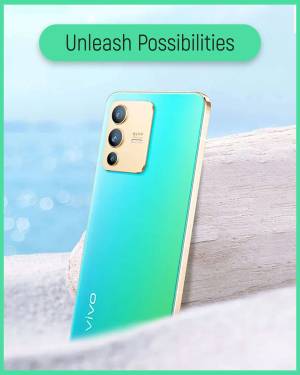 Close-up of a Vivo smartphone with a gradient teal and gold back, resting on a wooden surface.
