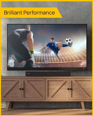 A modern TV displaying a soccer game, mounted on a wooden cabinet.