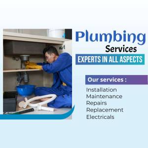 Plumber repairing pipes under a sink