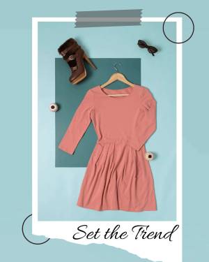 A flat lay of a pink dress, boots, sunglasses, and accessories on a light blue background.