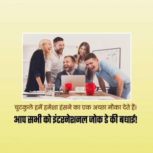 Group of colleagues laughing and looking at a laptop in an office setting