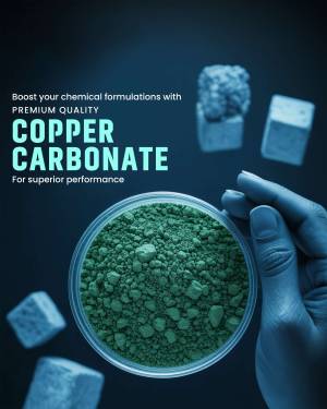 Image of green copper carbonate powder in a petri dish with chemical cubes and a hand holding a dish.