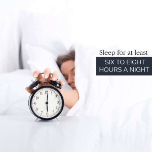Alarm clock in hand with a person in bed, promoting healthy sleep habits.