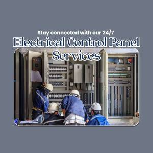 Electrical technicians working on a control panel