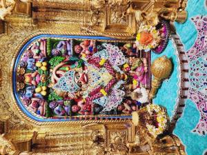 Close-up of a beautifully decorated Hanuman idol in a temple setting.