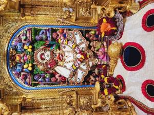 Close-up of a beautifully decorated Hanuman idol within a temple setting.
