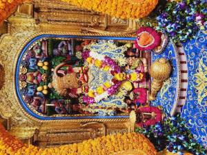Close-up of a beautifully decorated Hanuman idol in a temple setting.
