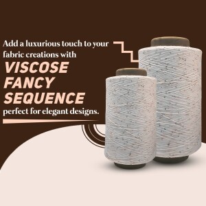 Three spools of white and grey viscose fancy sequence yarn on a brown background.