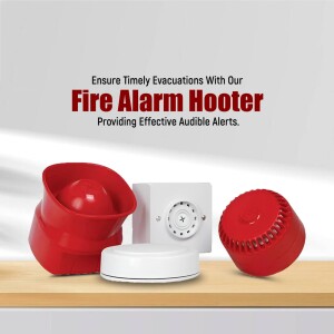 Red and white fire alarm hooters on a wooden surface