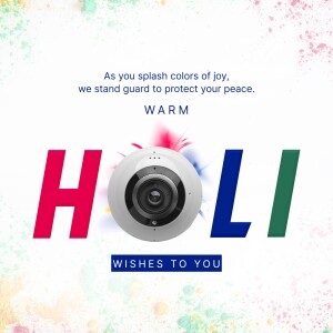 Security camera decorated with Holi colors and text wishing 'Happy Holi'.