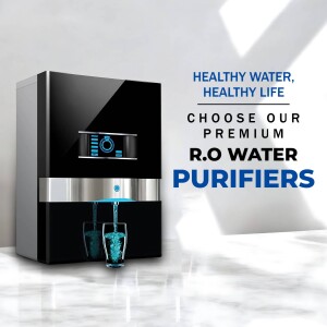 Black RO water purifier with water flowing into a glass