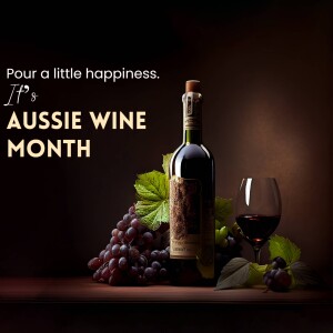 A bottle of red wine, a glass of wine, and a bunch of grapes on a wooden surface with text 'Pour a little happiness. It's Aussie Wine Month'.