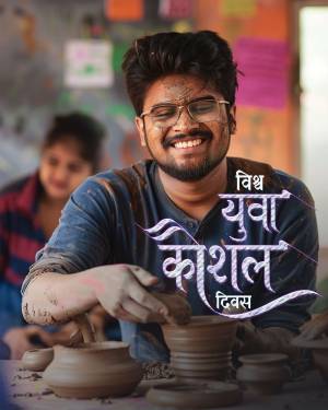 Young man smiling while working on pottery with text 'Yuva Kaushal Divas'