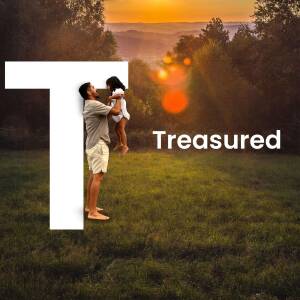 Father lifting daughter in front of a large letter 'T' at sunset