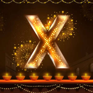 Glowing letter X with Diwali fireworks and lamps
