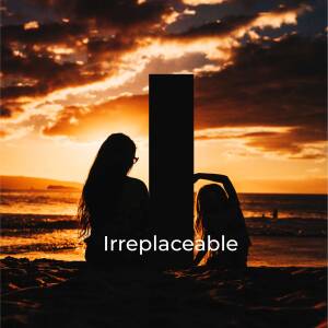 Silhouette of a mother and daughter watching a sunset on the beach