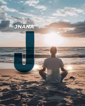 Man meditating on the beach with a large letter J in the foreground