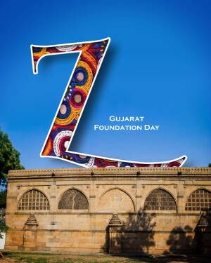 Stylized letter Z with Gujarati patterns against a blue sky and historical building