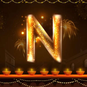 Golden letter N with Diwali lights and fireworks