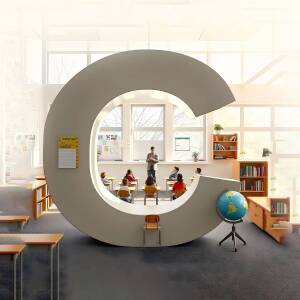 A large letter 'C' shaped opening in a classroom wall, framing students and a teacher.