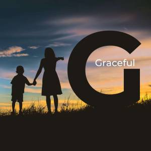 Silhouette of a mother and son holding hands in front of a large letter G with a sunset background.