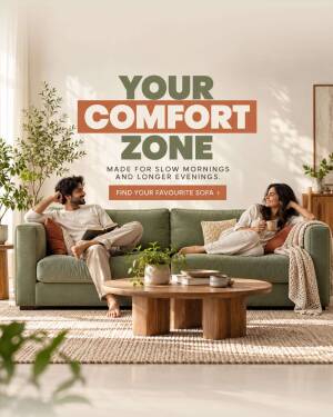 A man and woman relaxing on a sage green sofa in a warm, sunlit living room