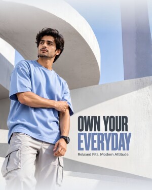 A stylish man wearing a light blue oversized t-shirt and cargo pants in an urban architectural setting