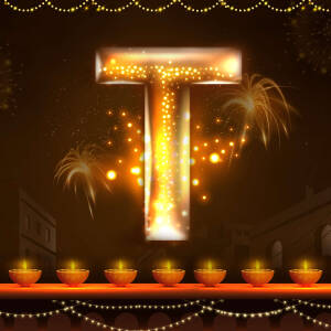 Letter T illuminated with Diwali lights and fireworks