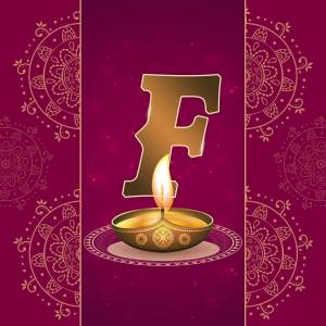 Golden letter F with a lit diya lamp for Diwali