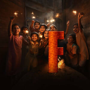 Group of children celebrating with sparklers and a large letter 'F'