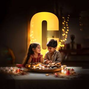 Two young children celebrating Diwali with lights and sweets.